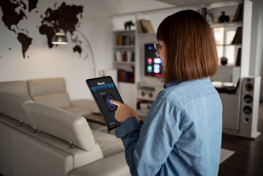 a woman who use tablet to control our smart home